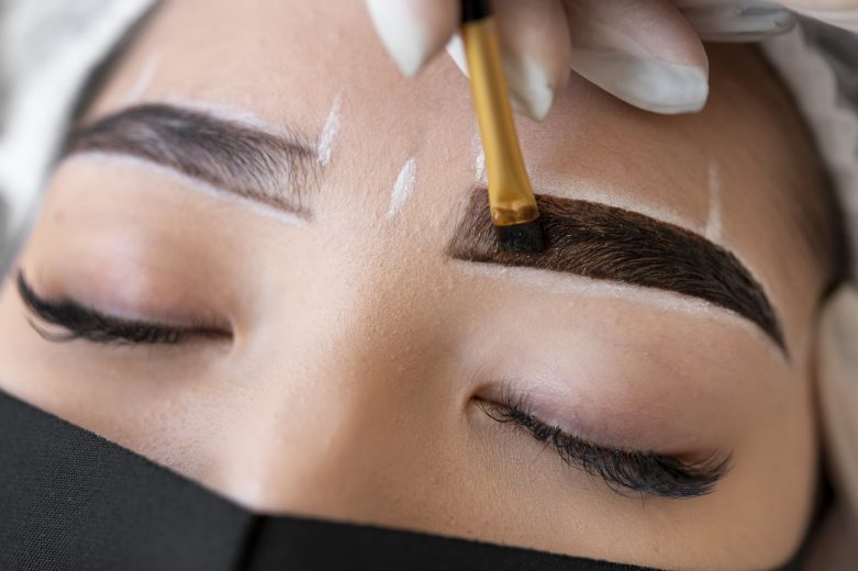 beautician-doing-microblading-treatment-client-s-eyebrows